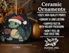 a christmas ornament with a turtle holding a present