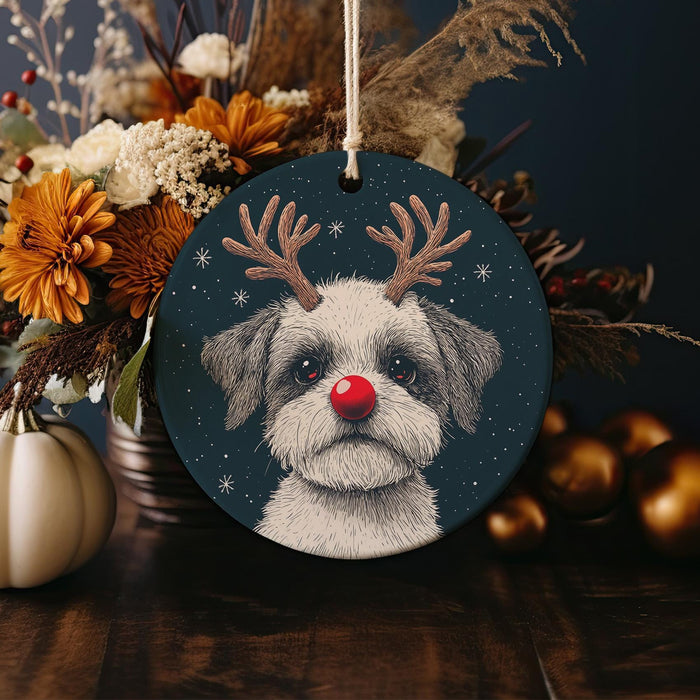 a christmas ornament with a dog wearing reindeer antlers