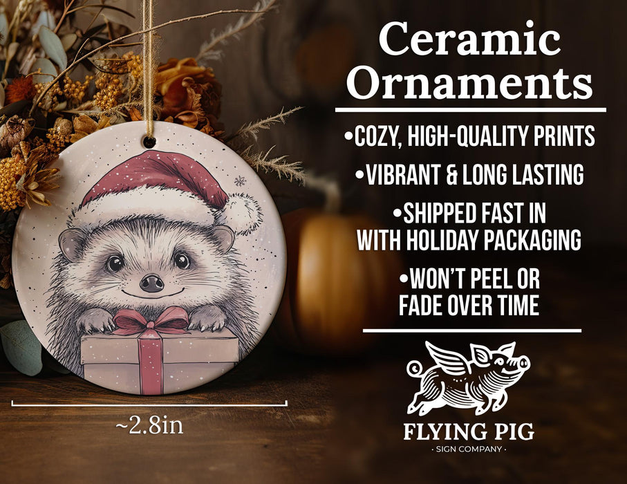 a ceramic ornament with a picture of a hedge holding a present