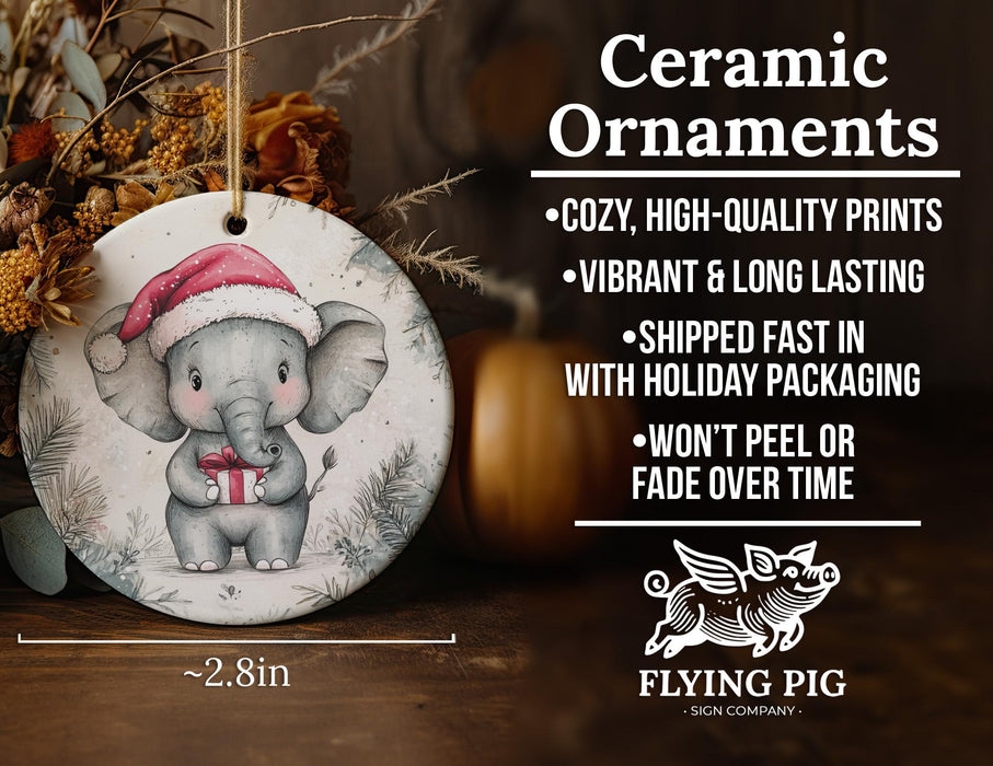a ceramic ornament with an elephant wearing a santa hat