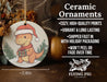 a ceramic ornament with a dinosaur wearing a santa hat