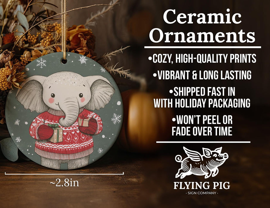 a ceramic ornament with an elephant wearing a sweater
