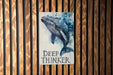 a sign that says deep thinker on a wooden wall
