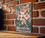 a bathroom sign on a brick wall next to a wooden table