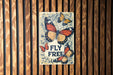 a wooden wall with a sign that says fly free