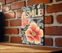 a sign that says smile on a brick wall