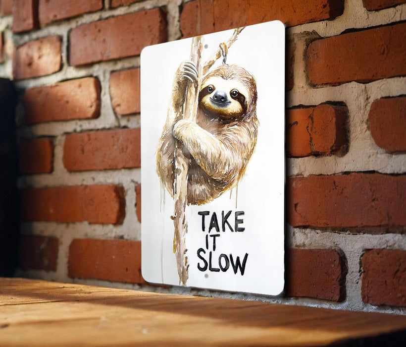 a picture of a sloth hanging on a brick wall