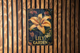 a painting of a lily on a wooden wall