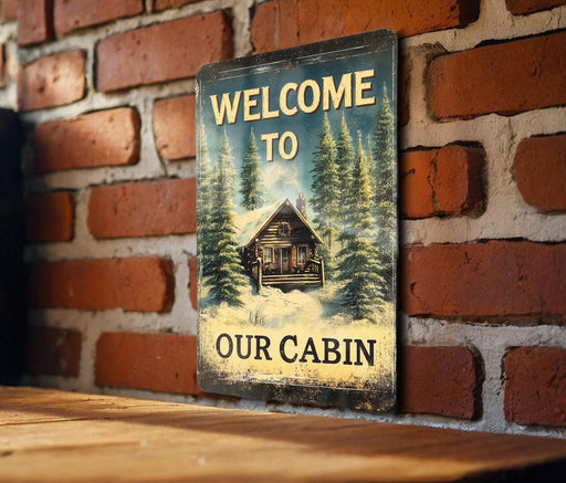 a welcome to our cabin sign on a brick wall