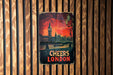 a sign on a wooden wall with a clock tower in the background