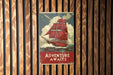 a sign on a wooden wall that says adventure awaits