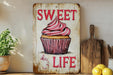 a sign that says sweet life with a cupcake on it