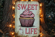 a sign with a picture of a cupcake on it