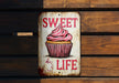 a sign that says sweet life with a cupcake on it
