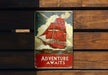 a sign on a wooden wall that says adventure awaits