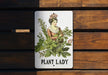 a plant lady sign on a wooden bench
