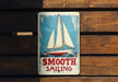 a tin sign with a sailboat on it