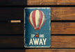 a sign that says up and away with a hot air balloon