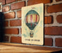 a picture of a hot air balloon on a brick wall