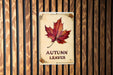 a sign on a wooden wall that says autumn leaves