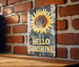 a picture of a sunflower on a brick wall