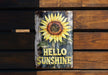 a wooden sign with a sunflower painted on it