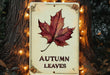 a sign with a leaf on it that says autumn leaves
