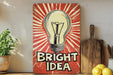 a painting of a light bulb with the words bright idea on it