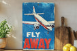 a sign that says fly away on a shelf