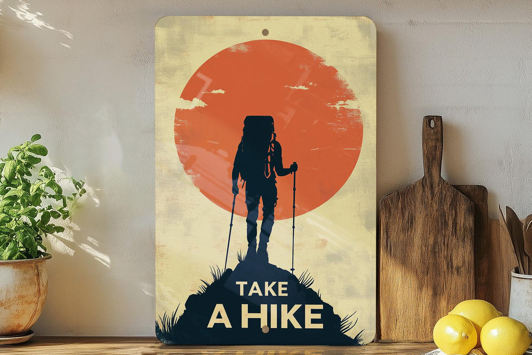 a poster of a hiker on a mountain with the sun in the background