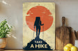 a poster of a hiker on a mountain with the sun in the background