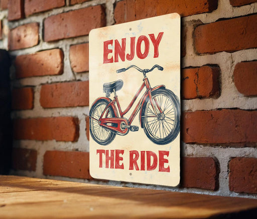 a sign that says enjoy the ride on a brick wall