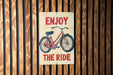 a sign that says enjoy the ride on a wooden wall