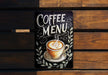 a sign on a wooden bench that says coffee menu