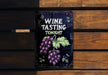 a wine tasting sign on a wooden bench