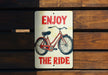 a sign that says enjoy the ride on a wooden bench
