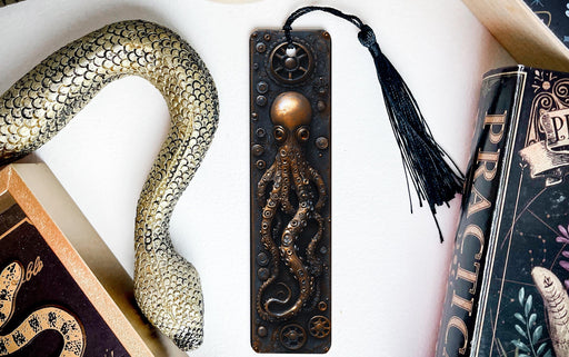 a bookmark, snake, and other books on a table