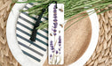 a plate with a bookmark and some flowers on it