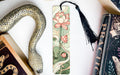 a snake, a bookmark, and some books on a table