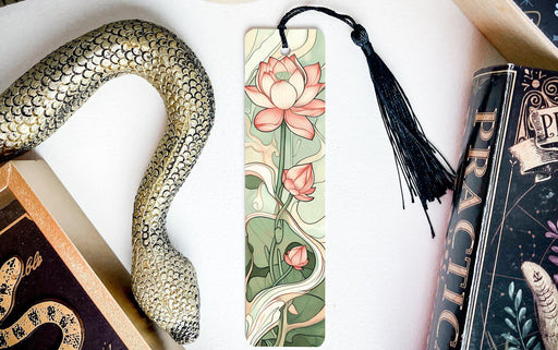 a snake, a bookmark, and some books on a table