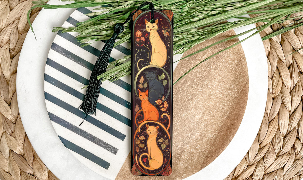 a wooden bookmark with a cat design on it