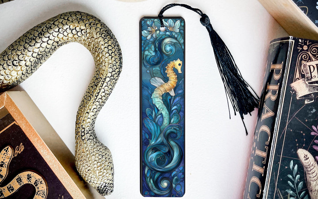 a bookmark with a seahorse on it next to books