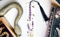 a bookmark with a snake and flowers on it