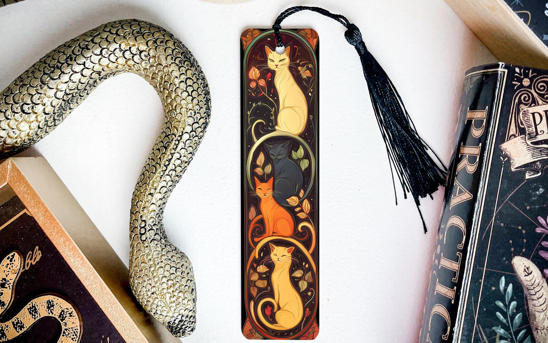 a bookmark with a cat and a snake on it