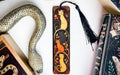 a bookmark with a cat and a snake on it