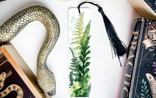 a bookmark with a picture of a plant and a snake on it
