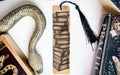 a bookmark with a snake and books on it