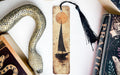 a bookmark with a sailboat on it next to a snake