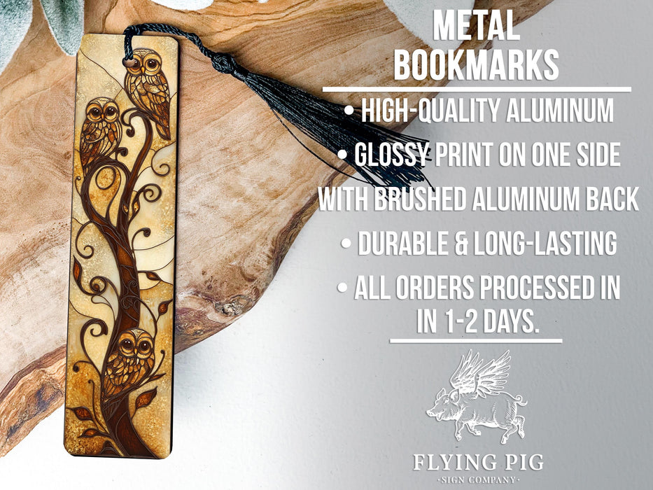 a metal bookmark with a tree design on it
