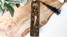 a wooden cross with a tassel hanging from it